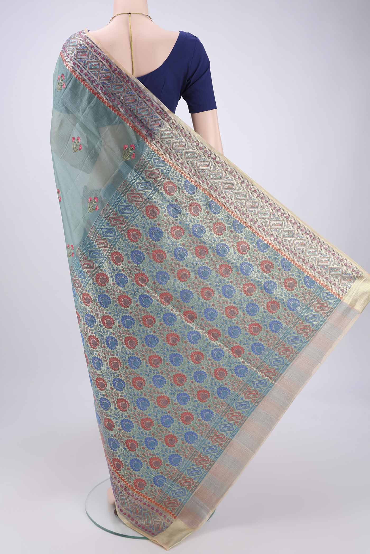 Flat view of Sea Green Banarasi Tussar Silk Saree with Zari Butta on the body and Zari And Thread Border. 