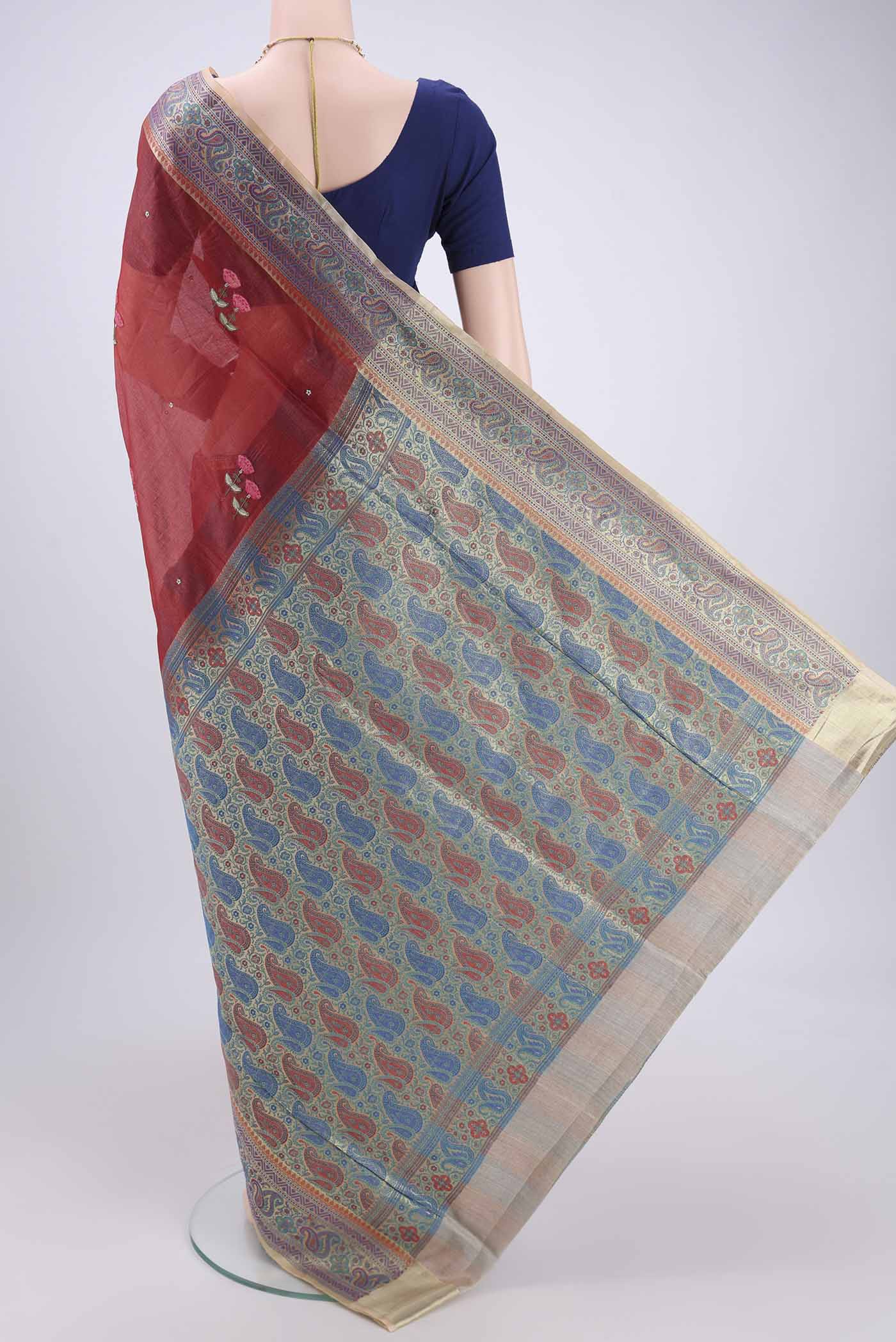 Flat view of Brick Orange Banarasi Tussar Silk Saree with Zari Butta on the body and Zari And Thread Border. 