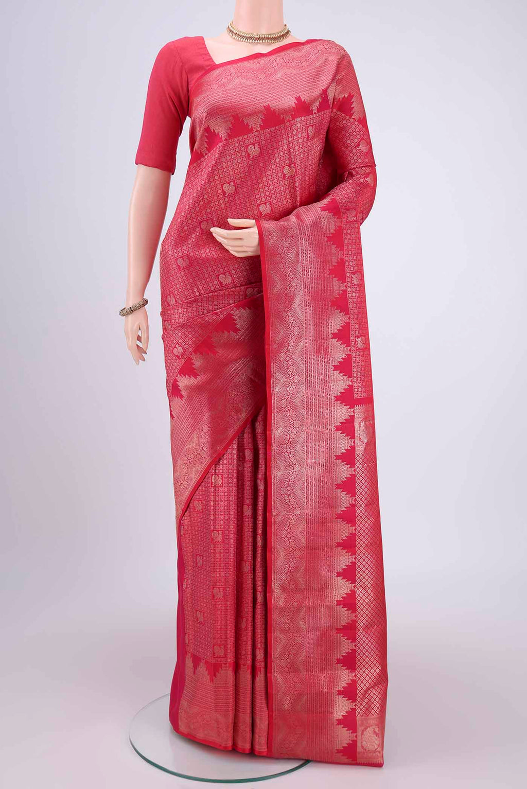 Pink Kanchipuram Silk Saree with Zari Butta on the body and Zari Border.  displayed on a mannequin