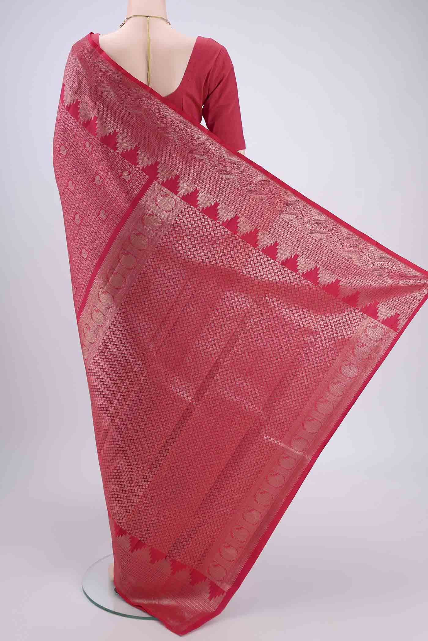 Flat view of Pink Kanchipuram Silk Saree with Zari Butta on the body and Zari Border. 
