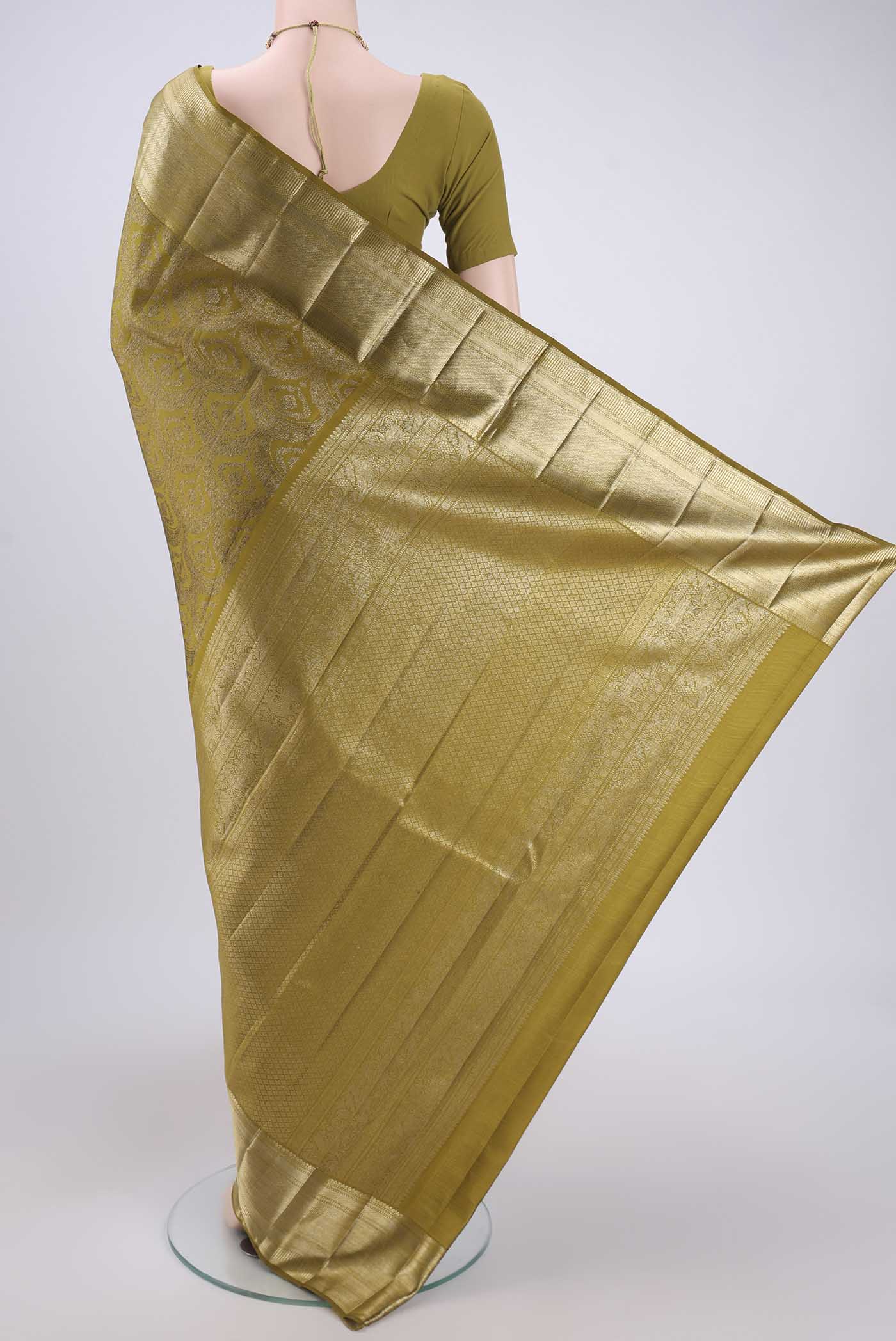 Flat view of Mehandi Green Kanchipuram Silk Saree with Zari Brocade on the body and Zari Border. 