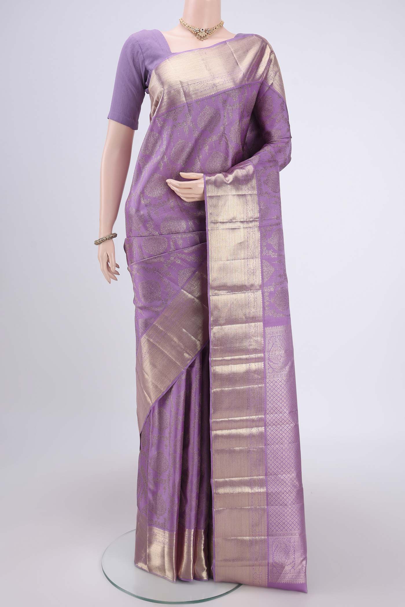 Lavender Kanchipuram Silk Saree with Zari Brocade on the body and Zari Border.  displayed on a mannequin