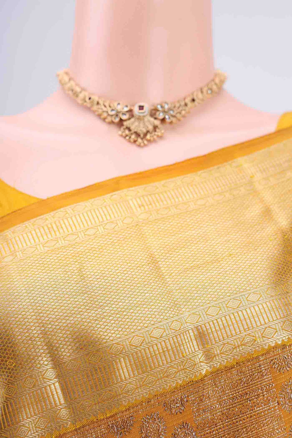 Border image of Yellow Kanchipuram Silk Saree with Zari Butta on the body and Zari Border. 