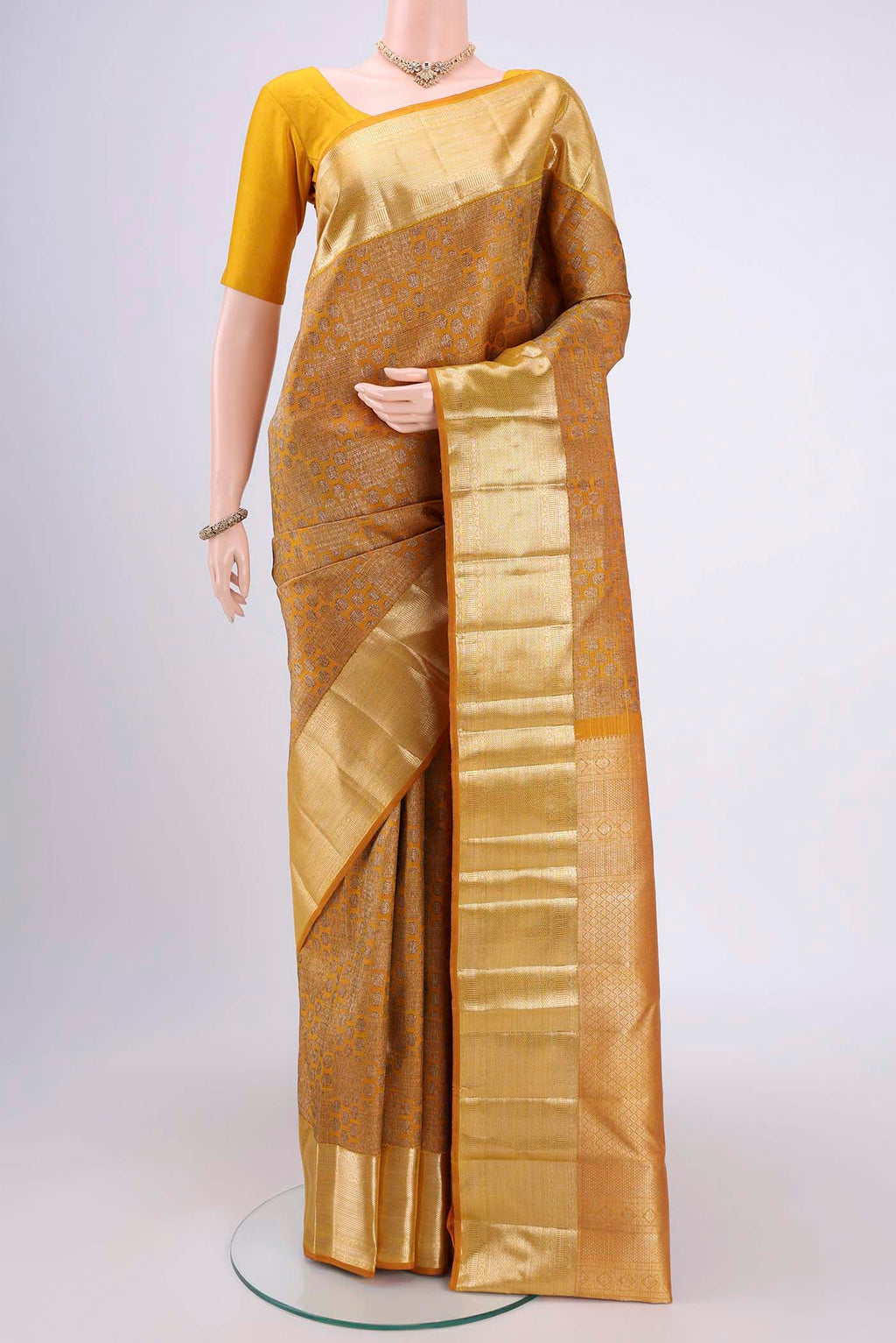 Yellow Kanchipuram Silk Saree with Zari Butta on the body and Zari Border.  displayed on a mannequin