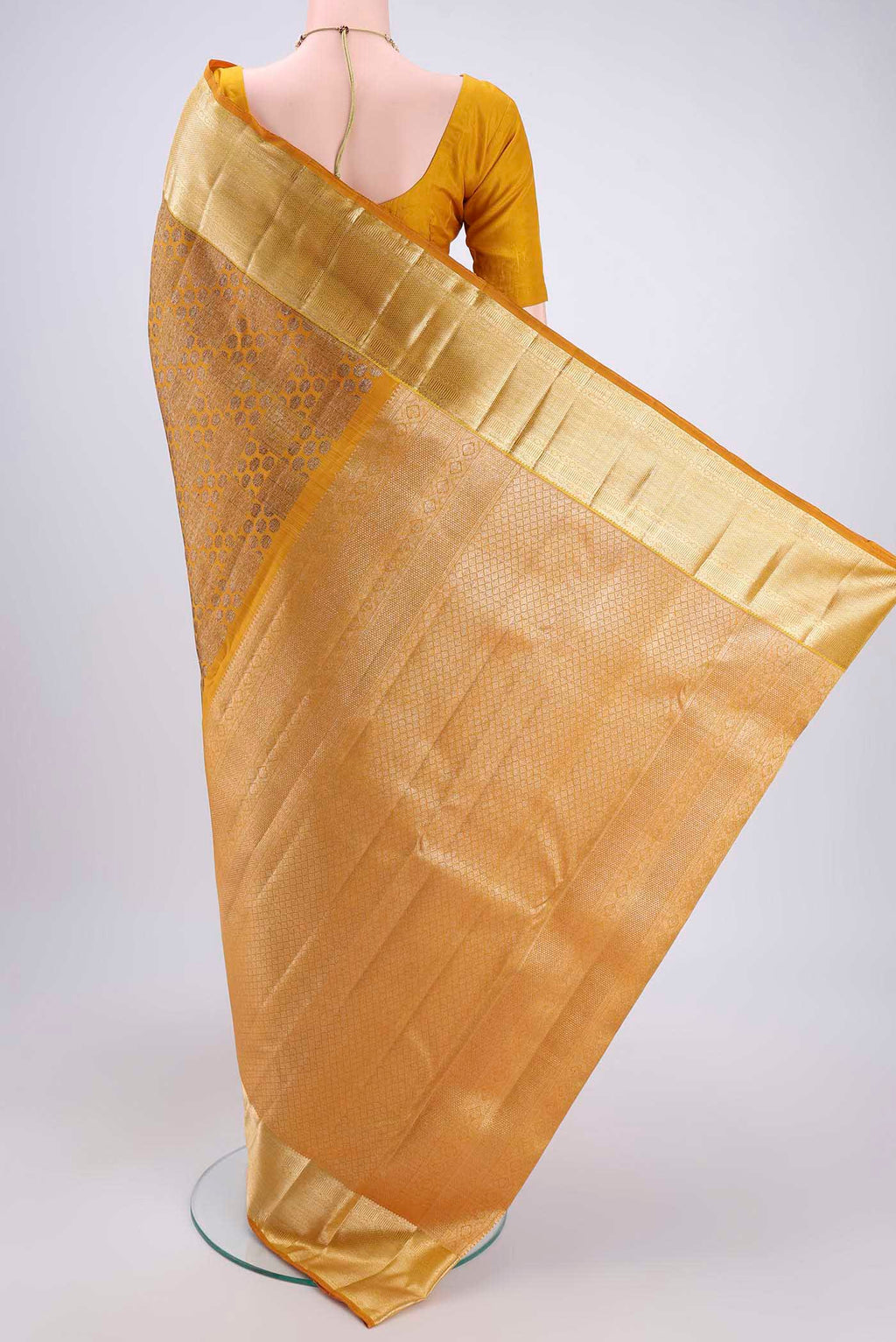 Flat view of Yellow Kanchipuram Silk Saree with Zari Butta on the body and Zari Border. 