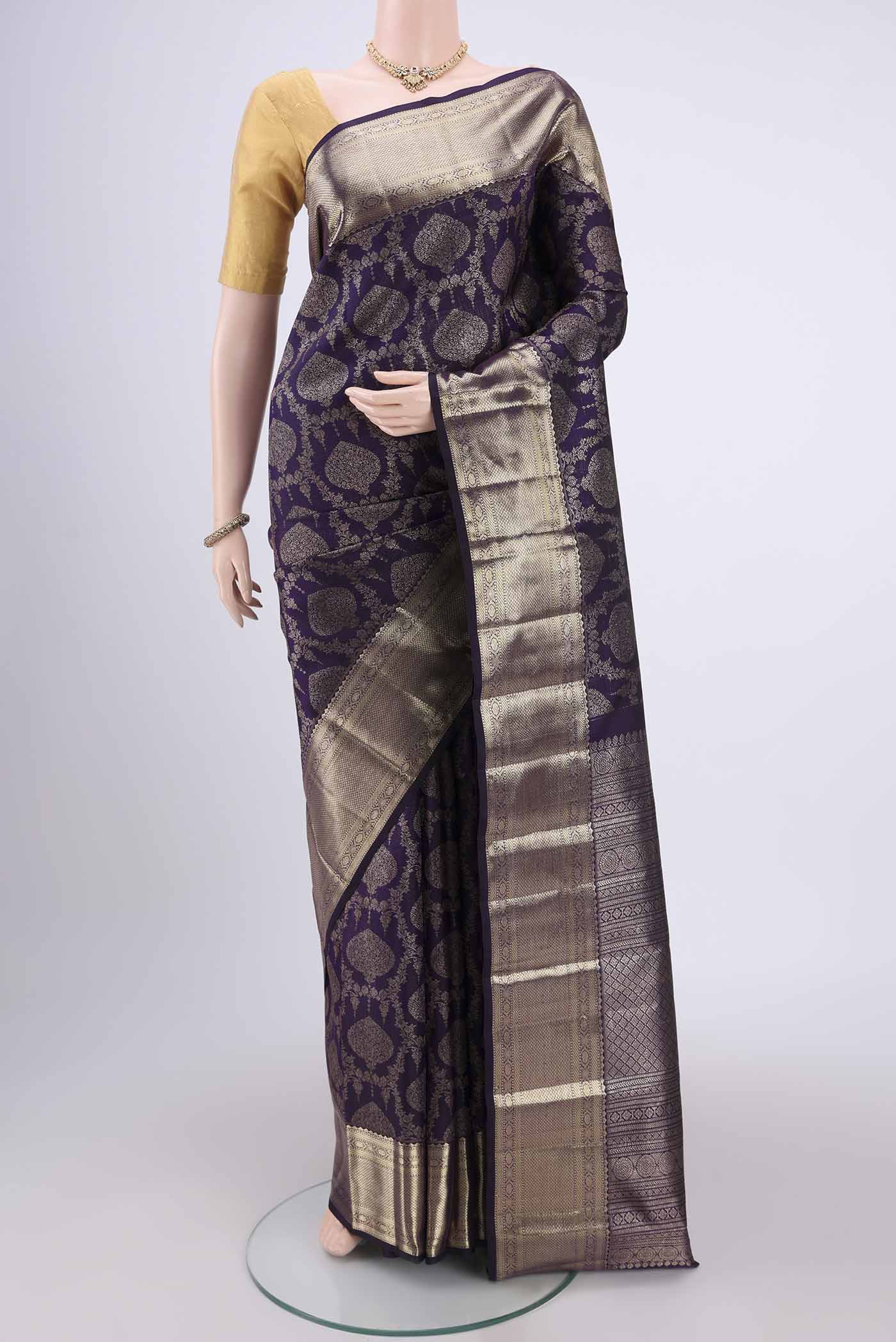 Purple Kanchipuram Silk Saree with Zari Brocade on the body and Zari Border.  displayed on a mannequin