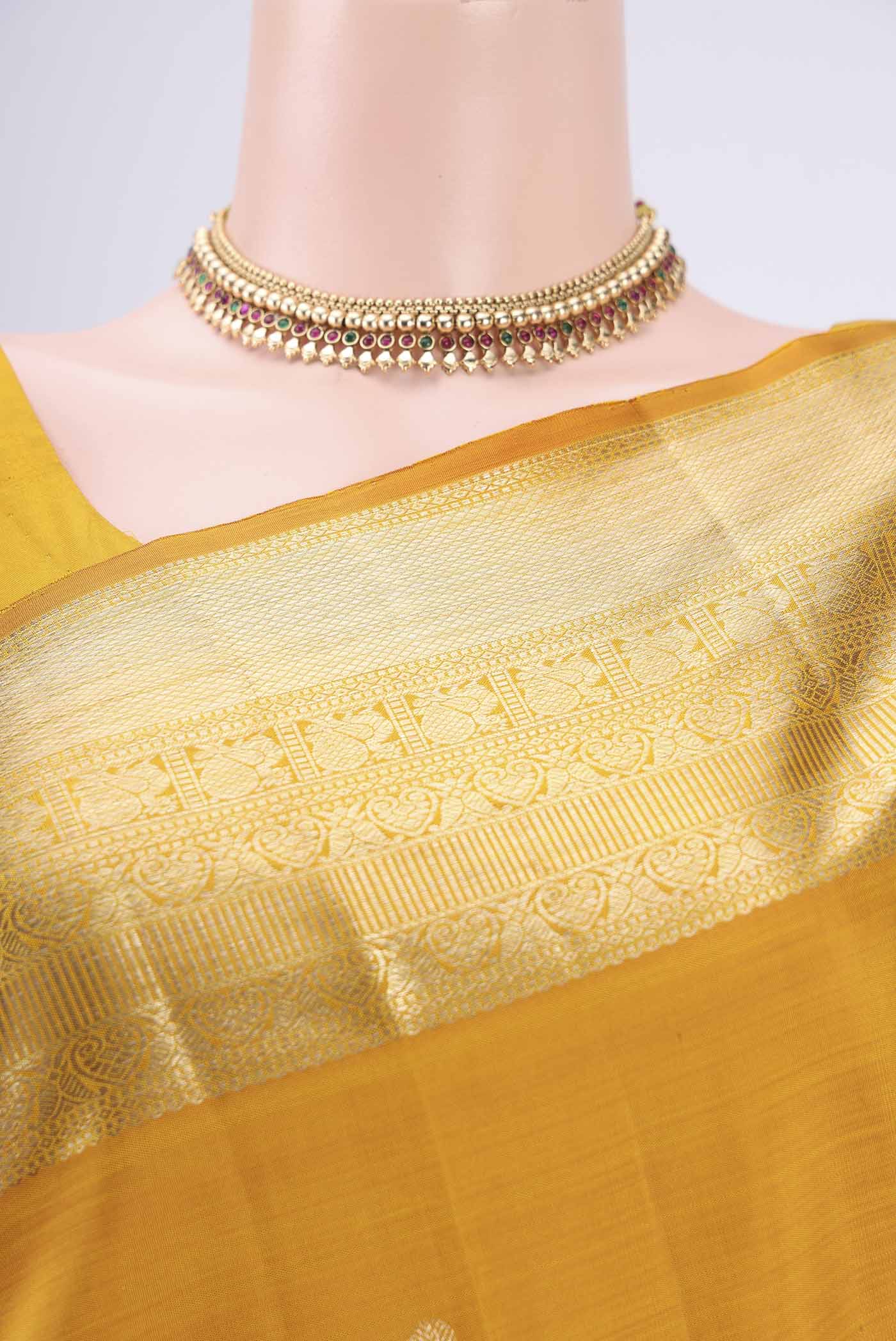 Border image of Yellow Kanjivaram Silk Saree with Zari Butta on the body and Zari Border. 