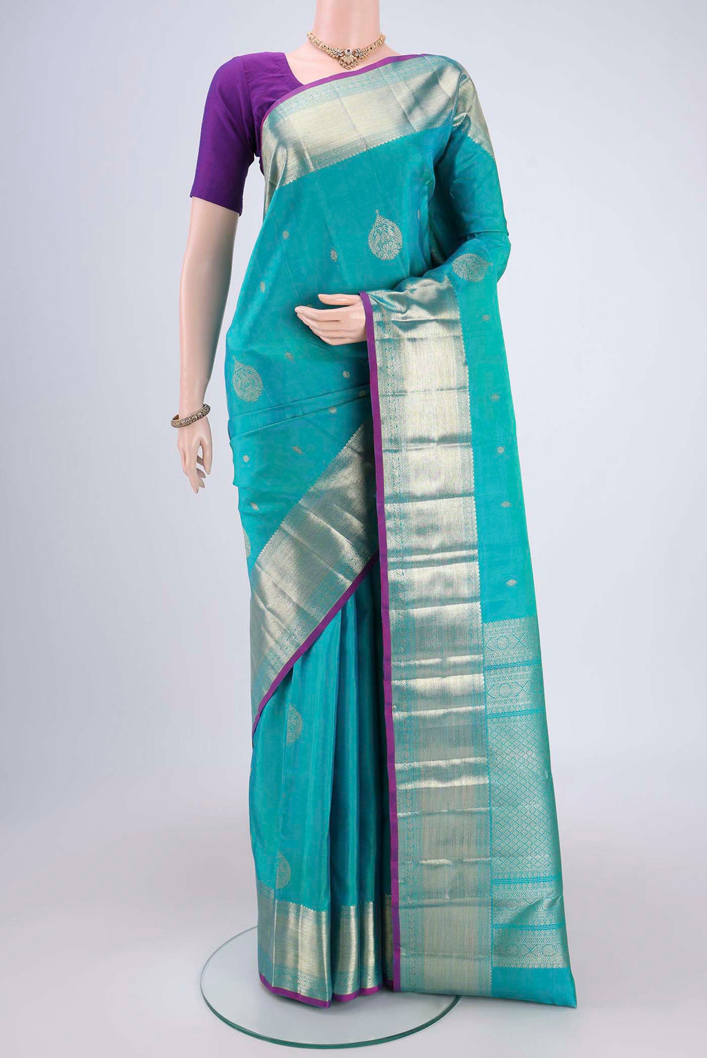 Blue Kanjivaram Silk Saree with Zari Butta on the body and Zari Border.  displayed on a mannequin
