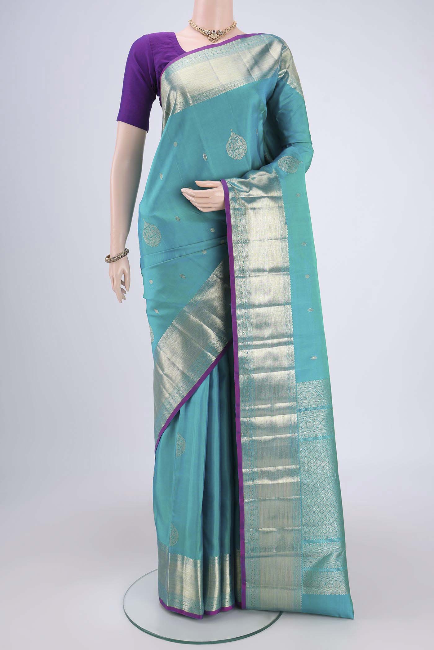 Blue Kanjivaram Silk Saree with Zari Butta on the body and Zari Border.  displayed on a mannequin