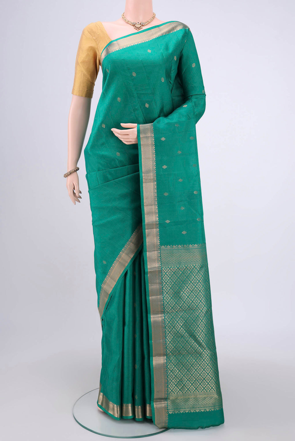 Sea Green Kanjivaram Silk Saree with Zari Butta on the body and Zari Border.  displayed on a mannequin