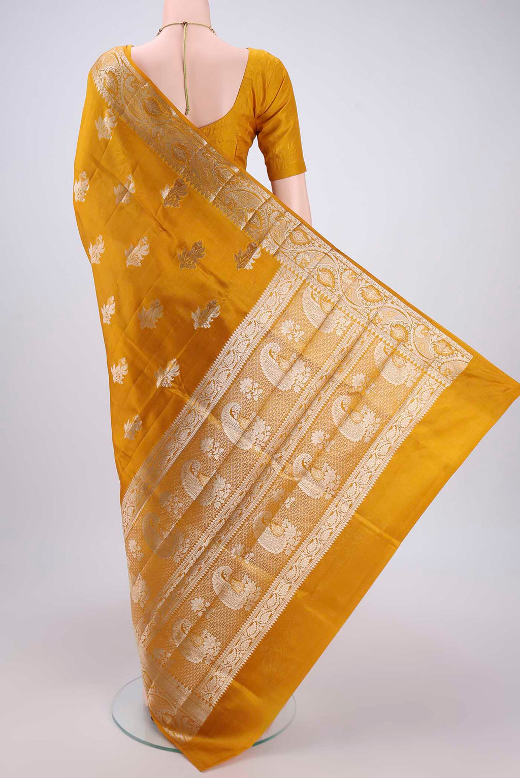 Flat view of Mustard Banarasi Raw Silk Saree with Zari Butta on the body and Zari Border. 