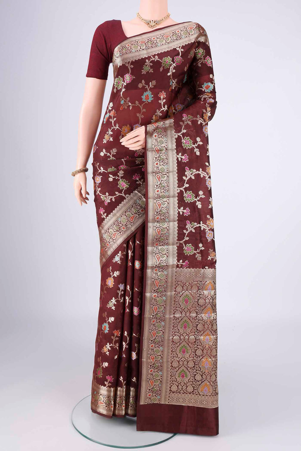 Brown Banarasi Raw Silk Saree with Zari Butta on the body and Zari Border.  displayed on a mannequin