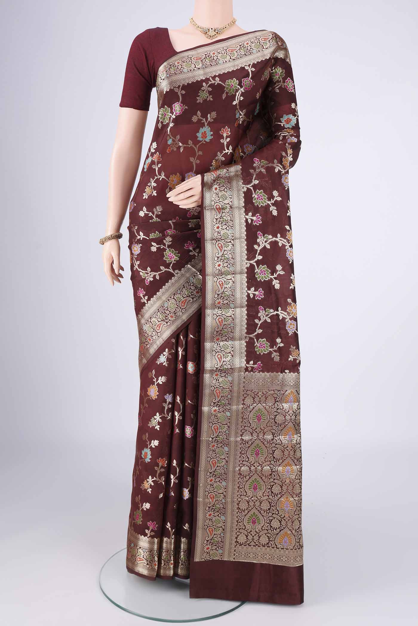 Brown Banarasi Raw Silk Saree with Zari Butta on the body and Zari Border.  displayed on a mannequin