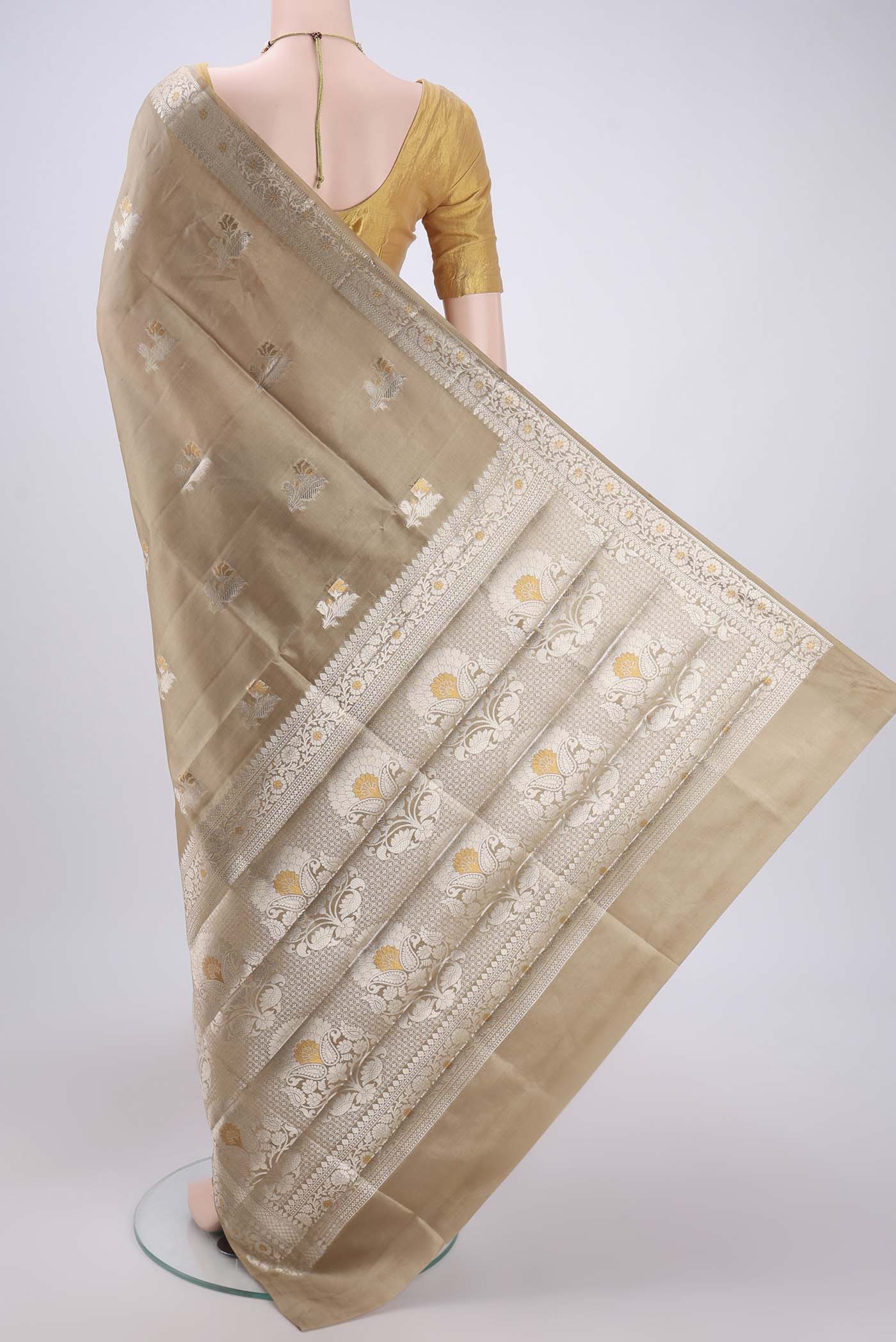 Flat view of Beige Banarasi Raw Silk Saree with Zari Butta on the body and Zari Border. 