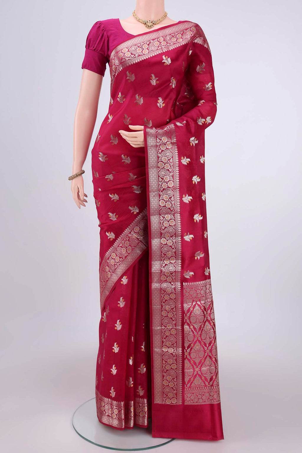 Rani Pink Banarasi Raw Silk Saree with Zari Butta on the body and Zari Border.  displayed on a mannequin