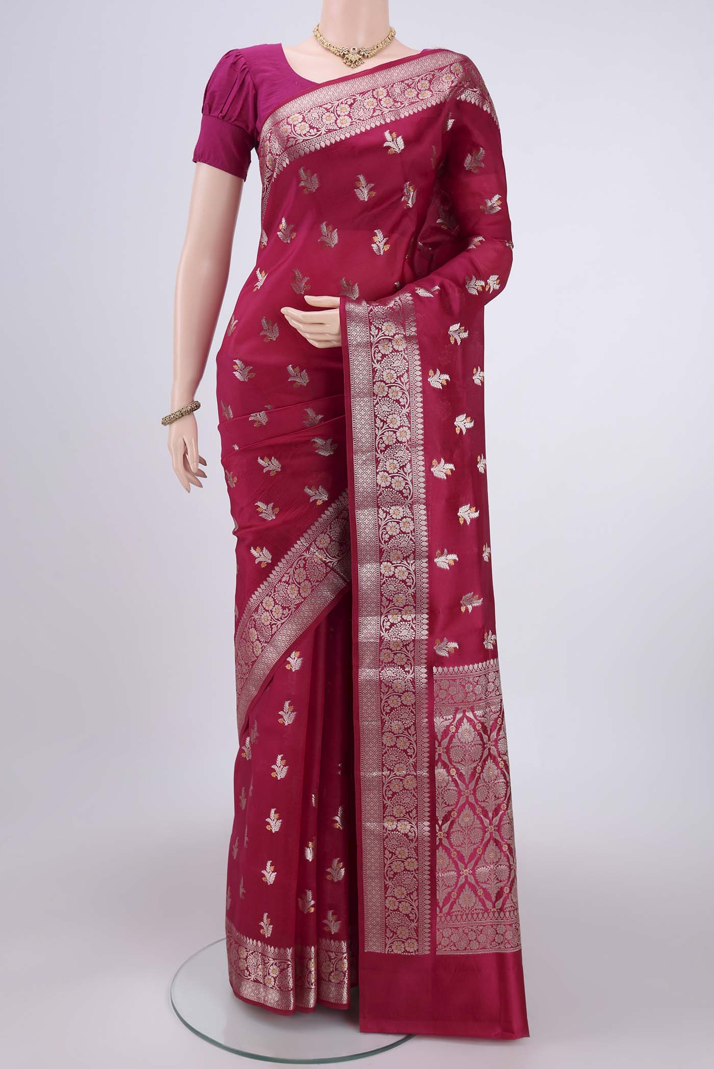 Rani Pink Banarasi Raw Silk Saree with Zari Butta on the body and Zari Border.  displayed on a mannequin