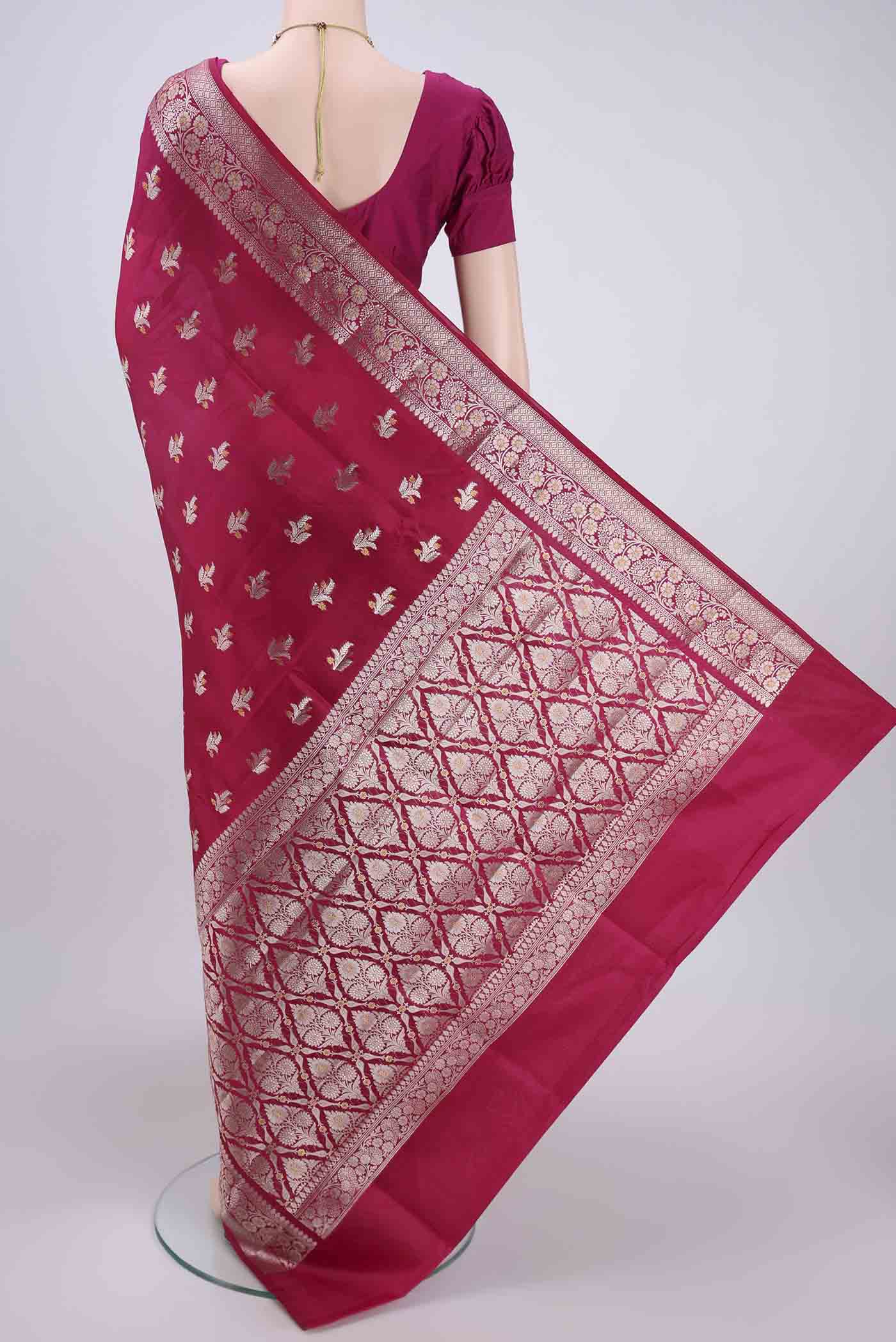 Flat view of Rani Pink Banarasi Raw Silk Saree with Zari Butta on the body and Zari Border. 