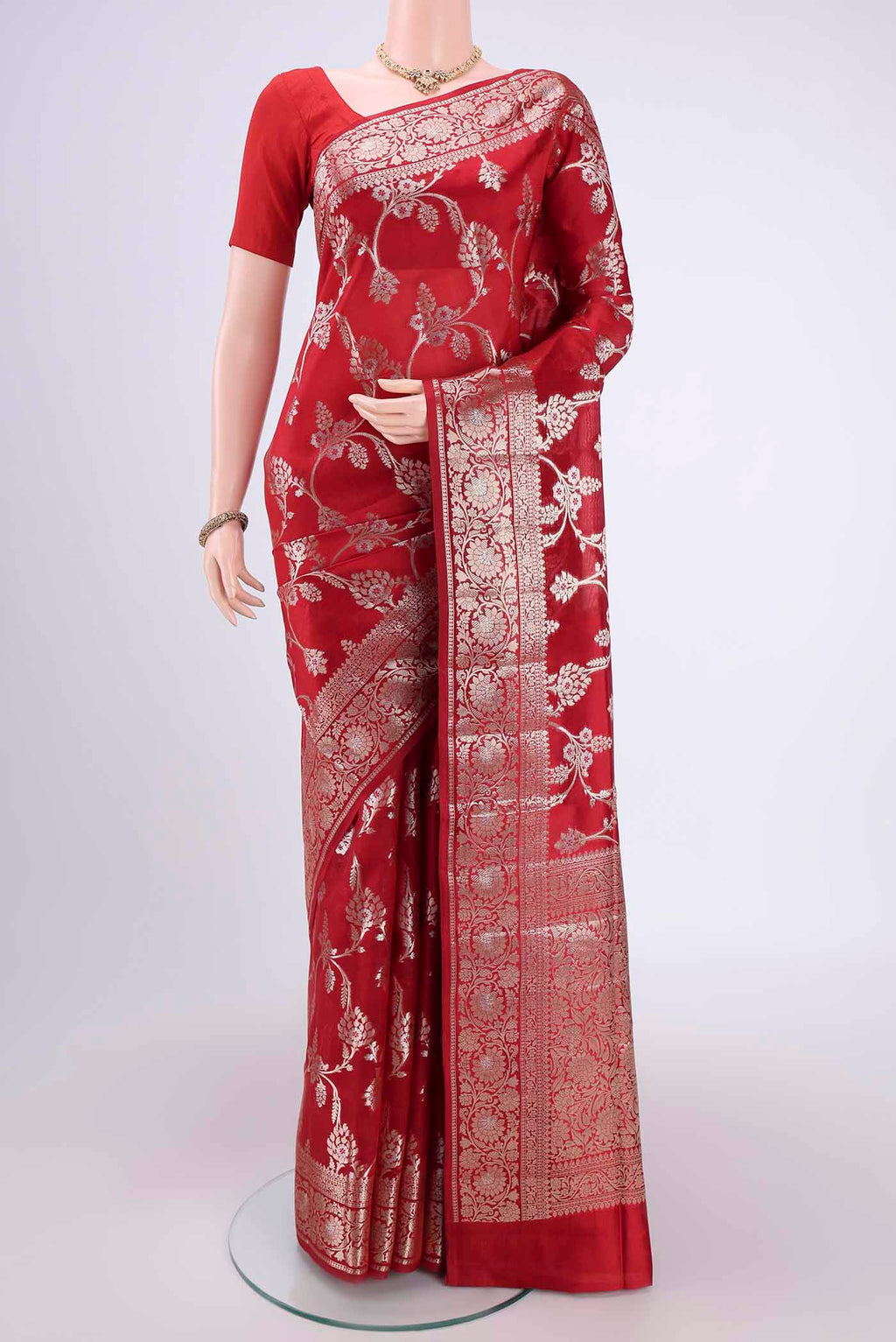 Maroon Banarasi Raw Silk Saree with Zari Butta on the body and Zari Border.  displayed on a mannequin