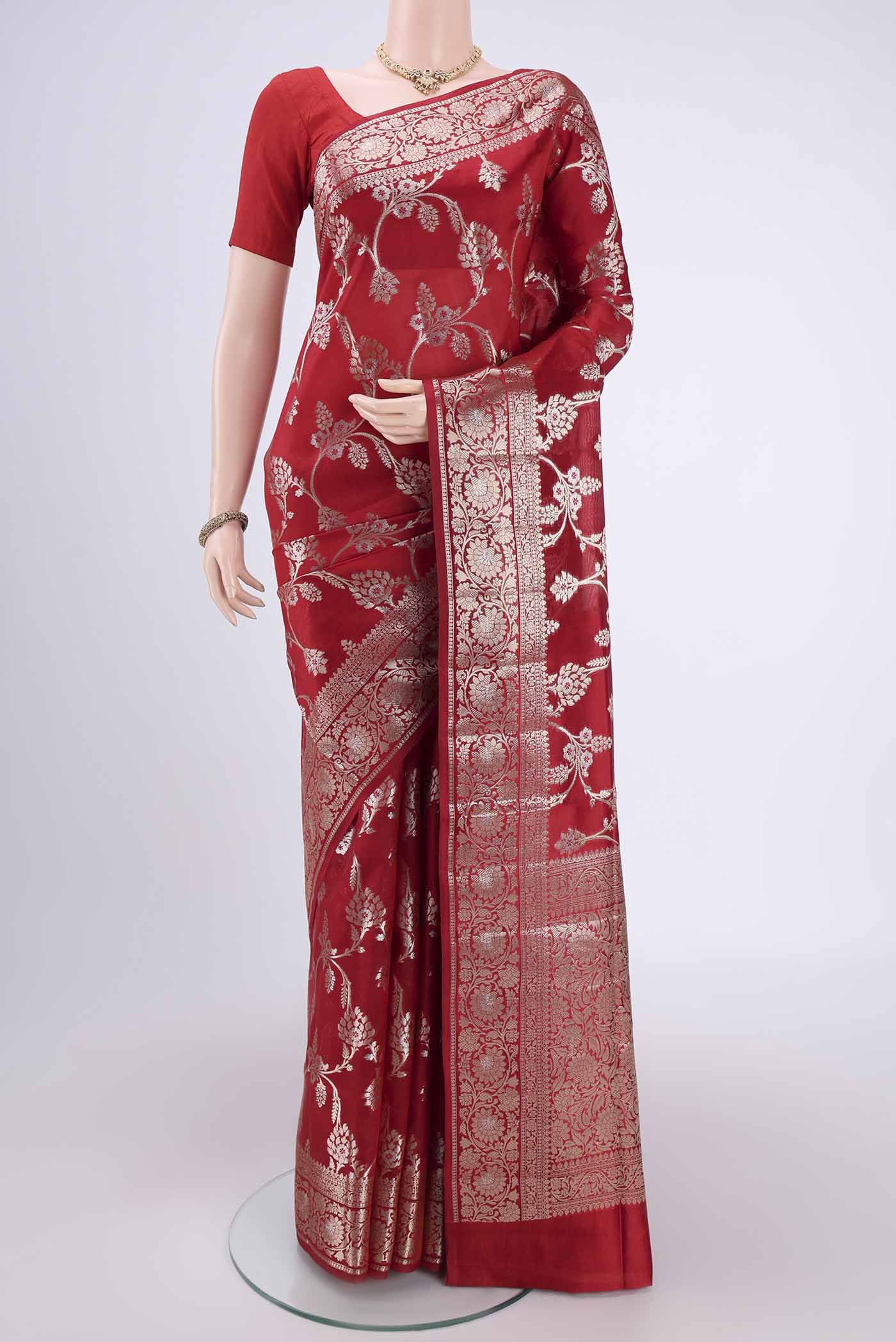Maroon Banarasi Raw Silk Saree with Zari Butta on the body and Zari Border.  displayed on a mannequin