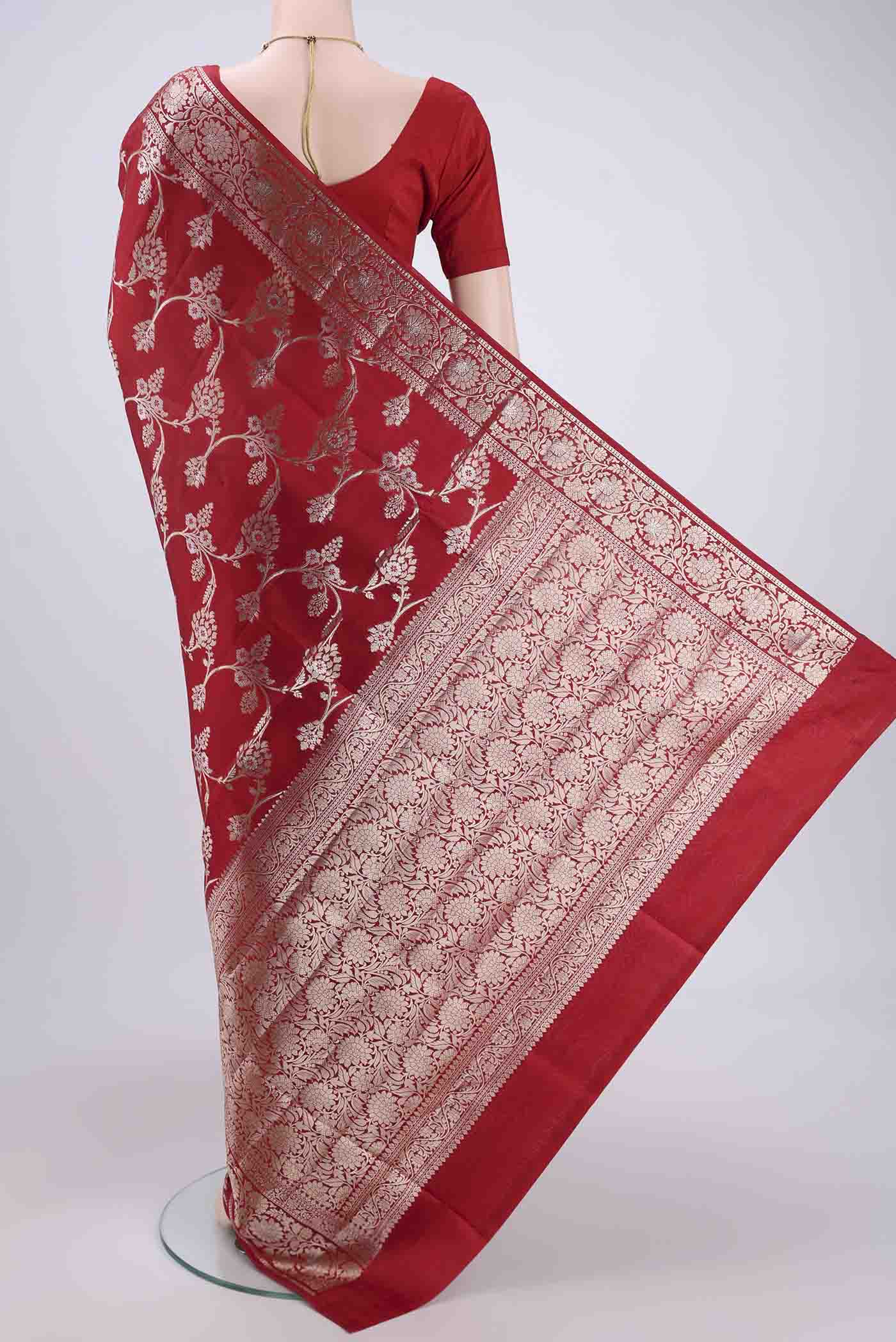 Flat view of Maroon Banarasi Raw Silk Saree with Zari Butta on the body and Zari Border. 