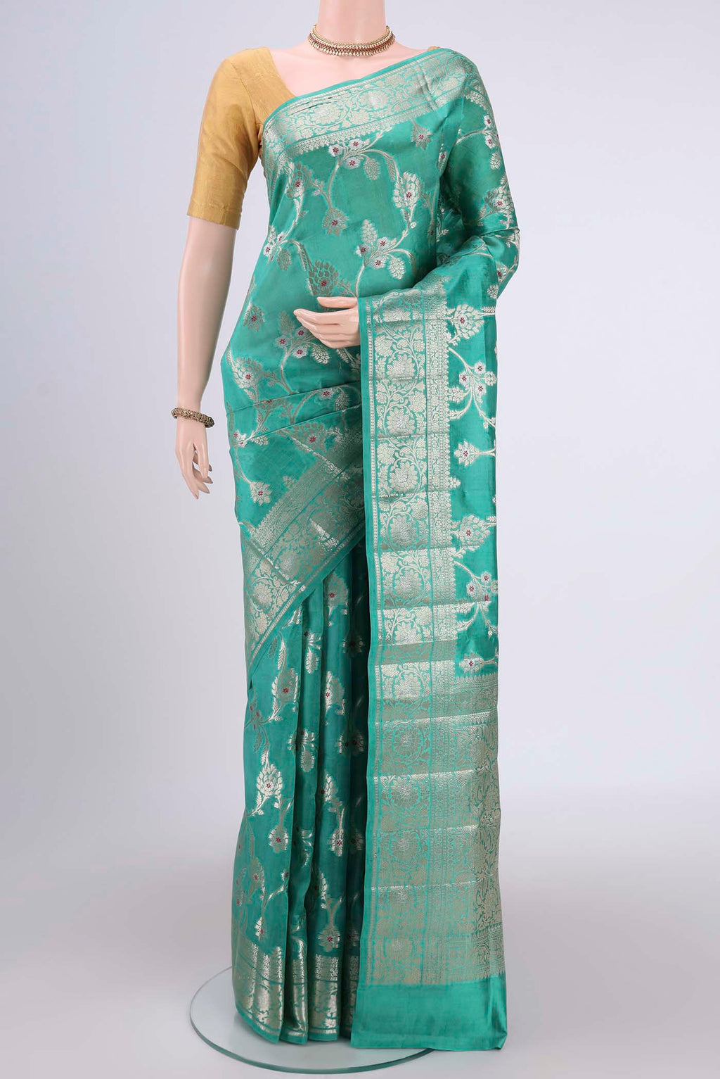 Sea Green Banarasi Raw Silk Saree with Zari Butta on the body and Zari Border.  displayed on a mannequin