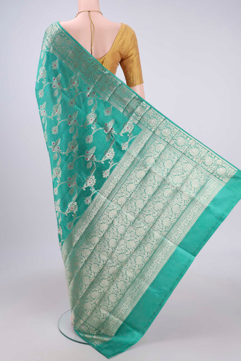 Flat view of Sea Green Banarasi Raw Silk Saree with Zari Butta on the body and Zari Border. 