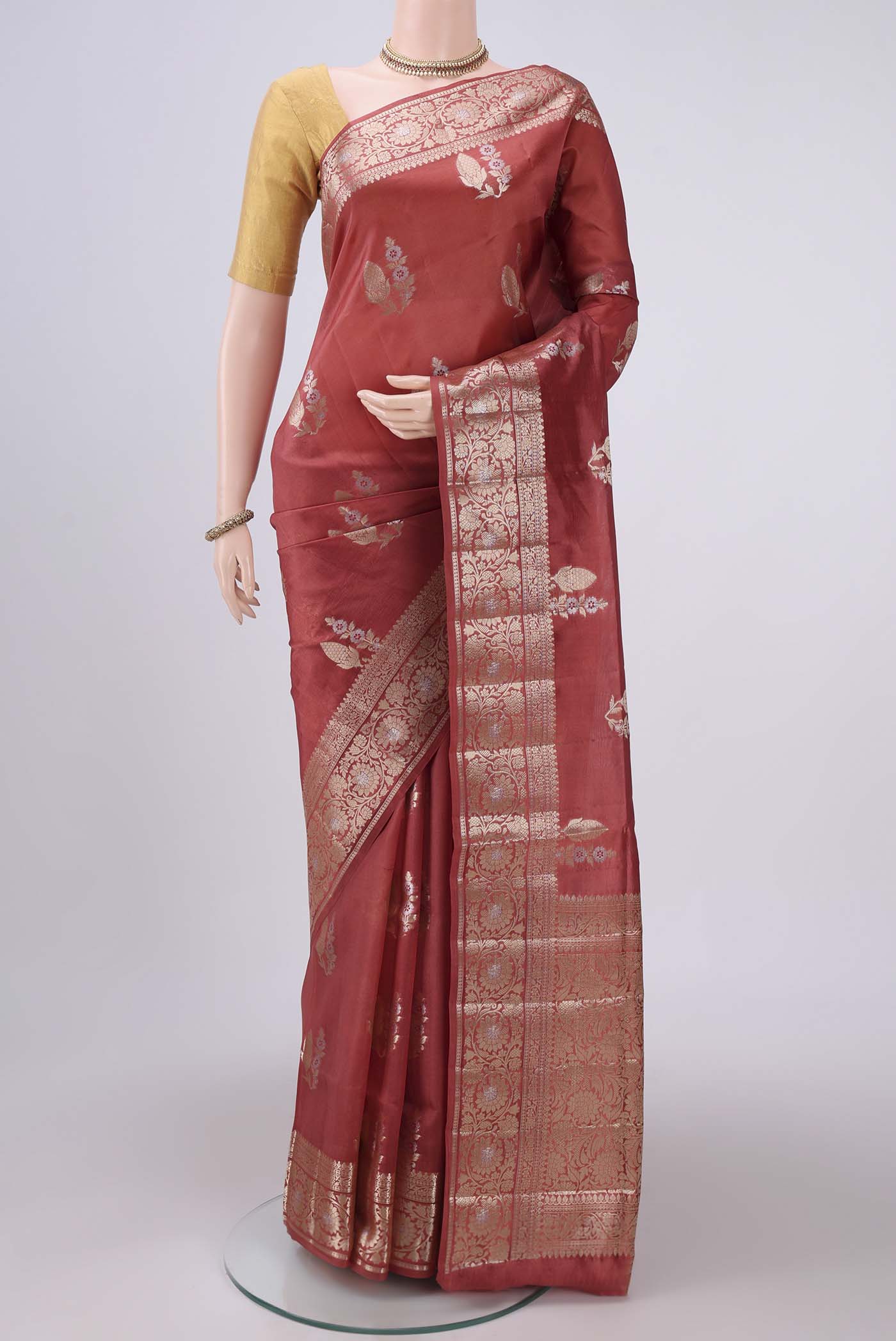 Rust Banarasi Raw Silk Saree with Zari Butta on the body and Zari Border.  displayed on a mannequin