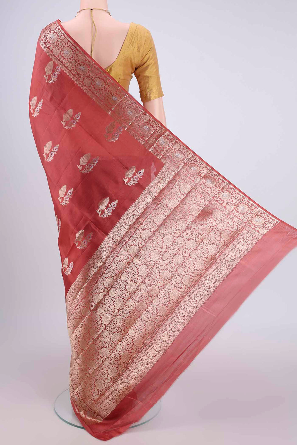 Flat view of Rust Banarasi Raw Silk Saree with Zari Butta on the body and Zari Border. 