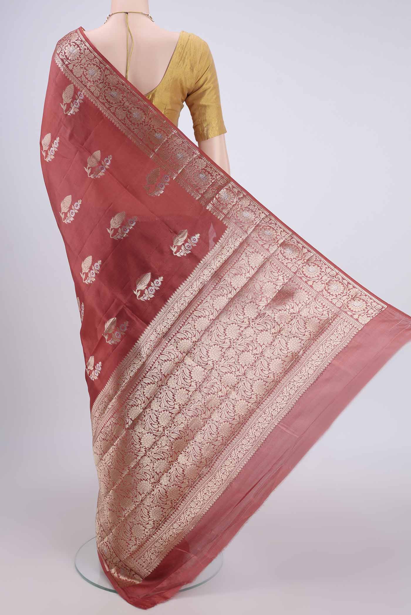 Flat view of Rust Banarasi Raw Silk Saree with Zari Butta on the body and Zari Border. 