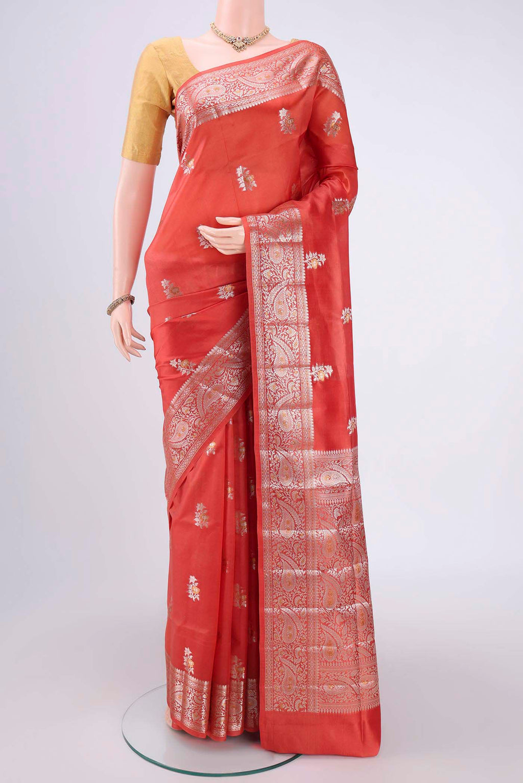 Peach Banarasi Raw Silk Saree with Zari Butta on the body and Zari Border.  displayed on a mannequin