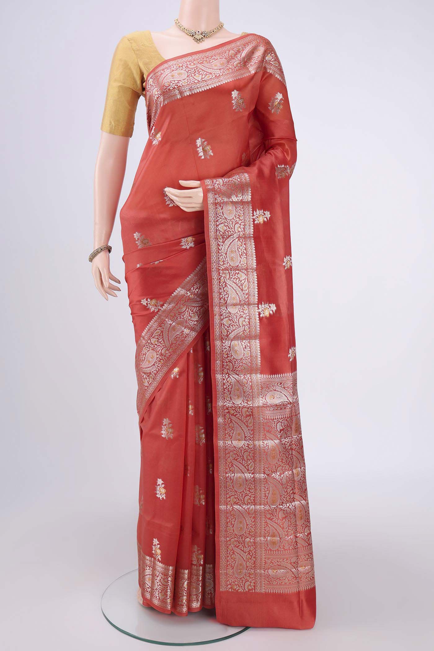 Peach Banarasi Raw Silk Saree with Zari Butta on the body and Zari Border.  displayed on a mannequin