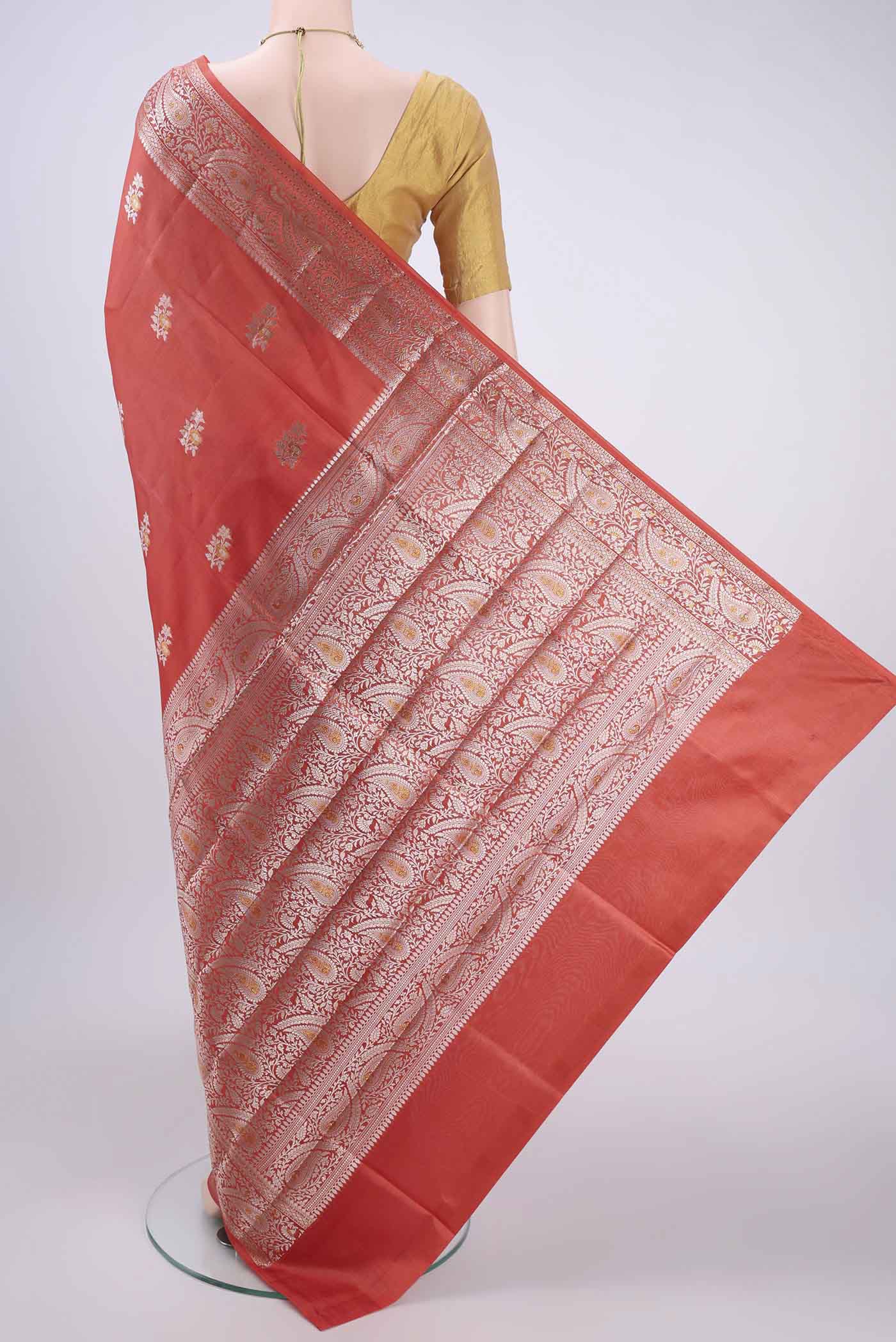 Flat view of Peach Banarasi Raw Silk Saree with Zari Butta on the body and Zari Border. 