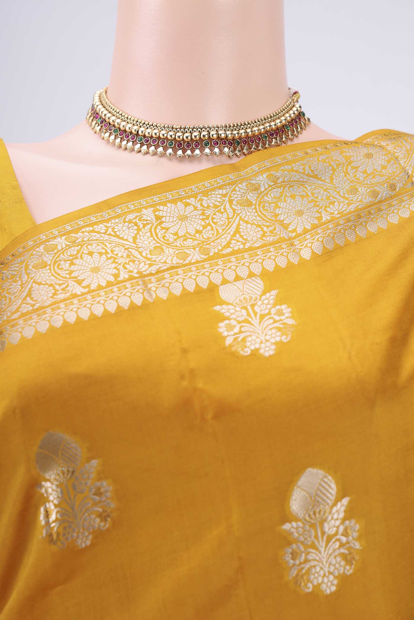 Border image of Yellow Banarasi Raw Silk Saree with Zari Butta on the body and Zari Border. 