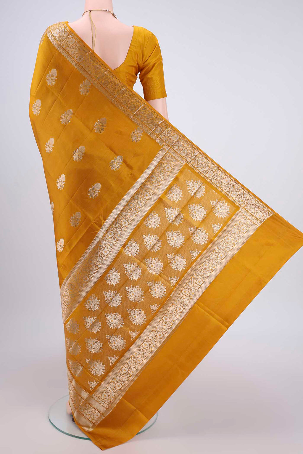 Flat view of Yellow Banarasi Raw Silk Saree with Zari Butta on the body and Zari Border. 