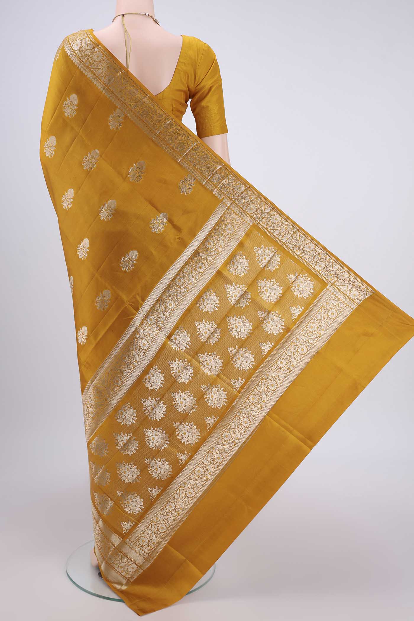 Flat view of Yellow Banarasi Raw Silk Saree with Zari Butta on the body and Zari Border. 
