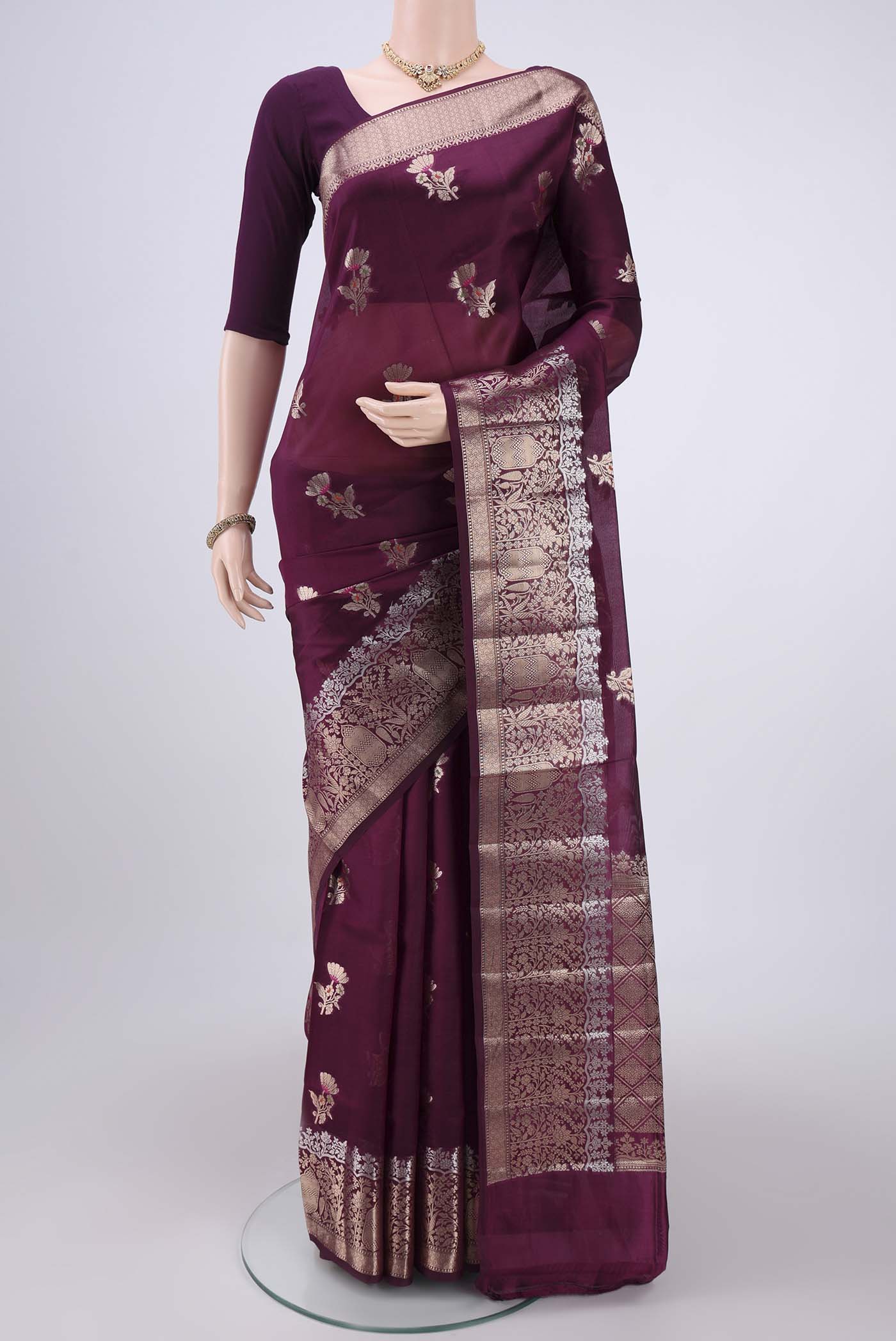 Magenta Banarasi Raw Silk Saree with Zari Butta on the body and Zari Border.  displayed on a mannequin