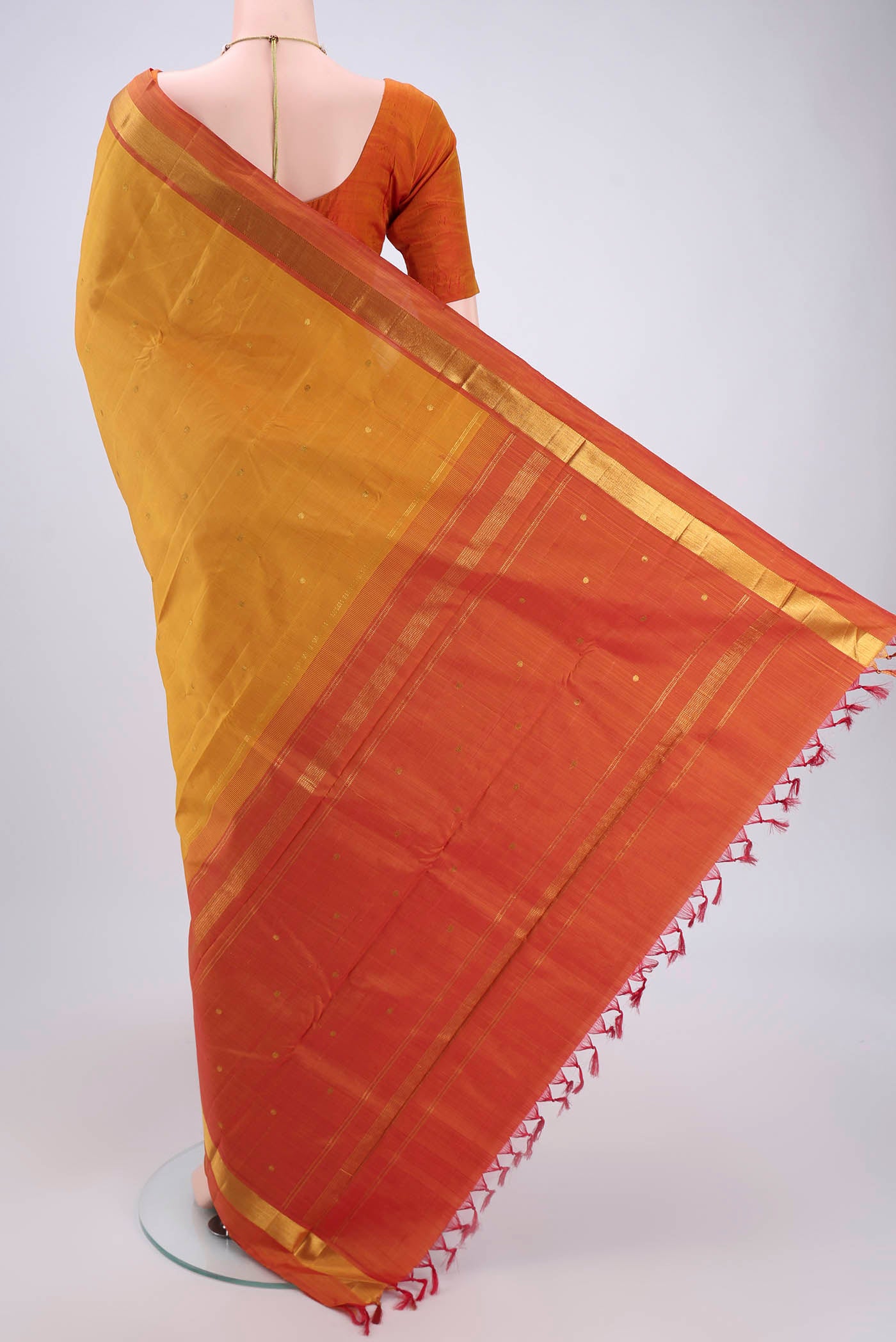 Flat view of Mustard Dual Tone Kanjivaram Silk Saree with Zari Butta on the body and Zari Border. 