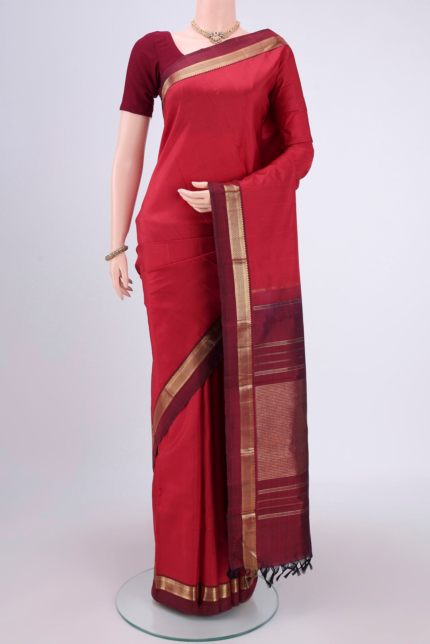 Pure Silk Pure Zari Deep Red Kanjivaram Saree with Zari Butta on the body and Zari Border.  displayed on a mannequin