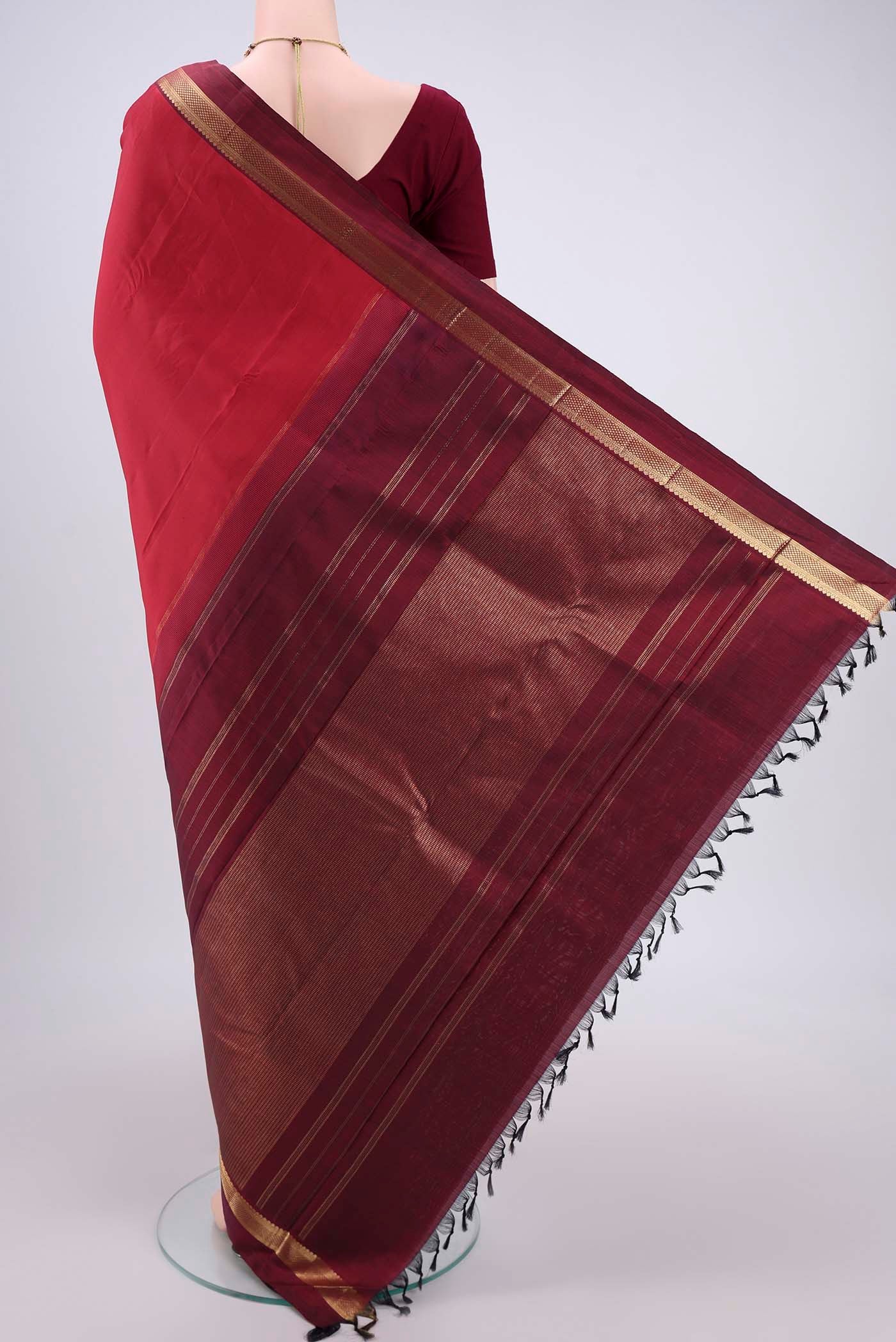 Flat view of Pure Silk Pure Zari Deep Red Kanjivaram Saree with Zari Butta on the body and Zari Border. 