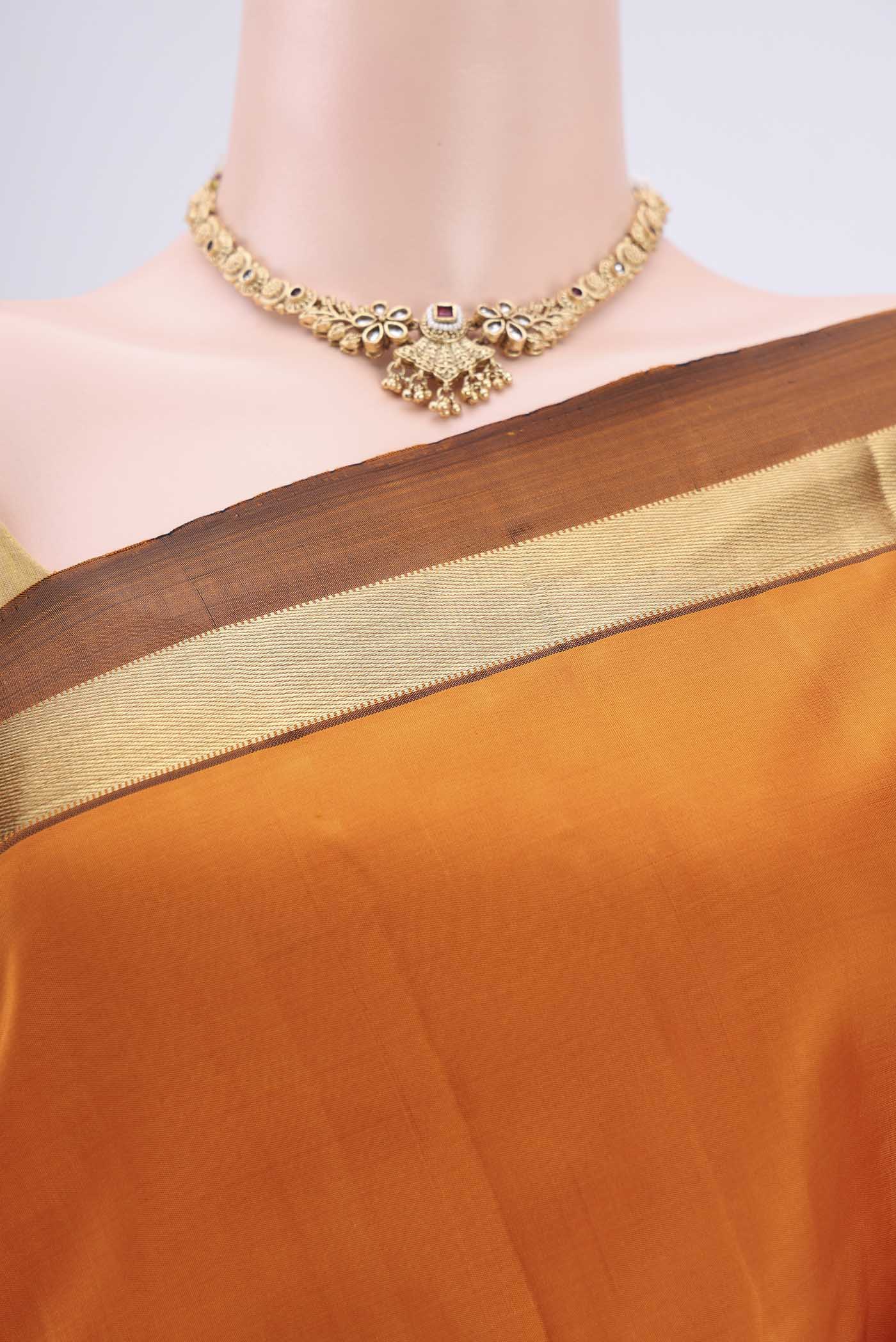 Border image of Mustard Dual Tone Kanjivaram Silk Saree with Plain Body and Zari Border. 