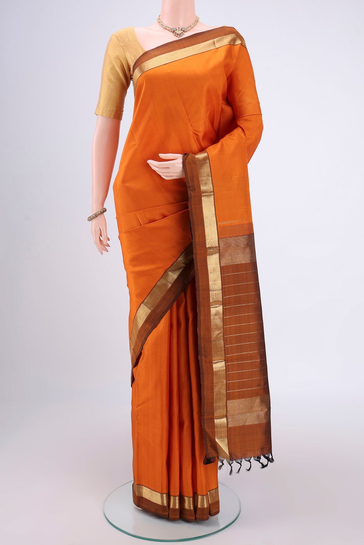 Mustard Dual Tone Kanjivaram Silk Saree with Plain Body and Zari Border.  displayed on a mannequin
