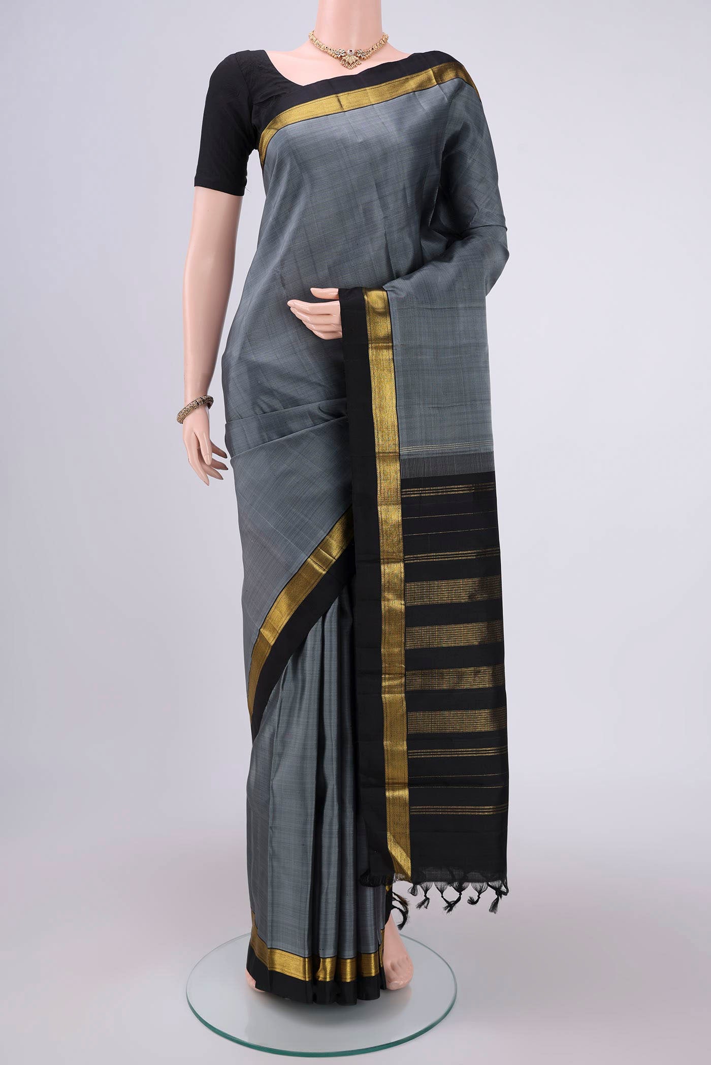 Grey Kanjivaram Silk Saree with Plain Body and Zari Border.  displayed on a mannequin