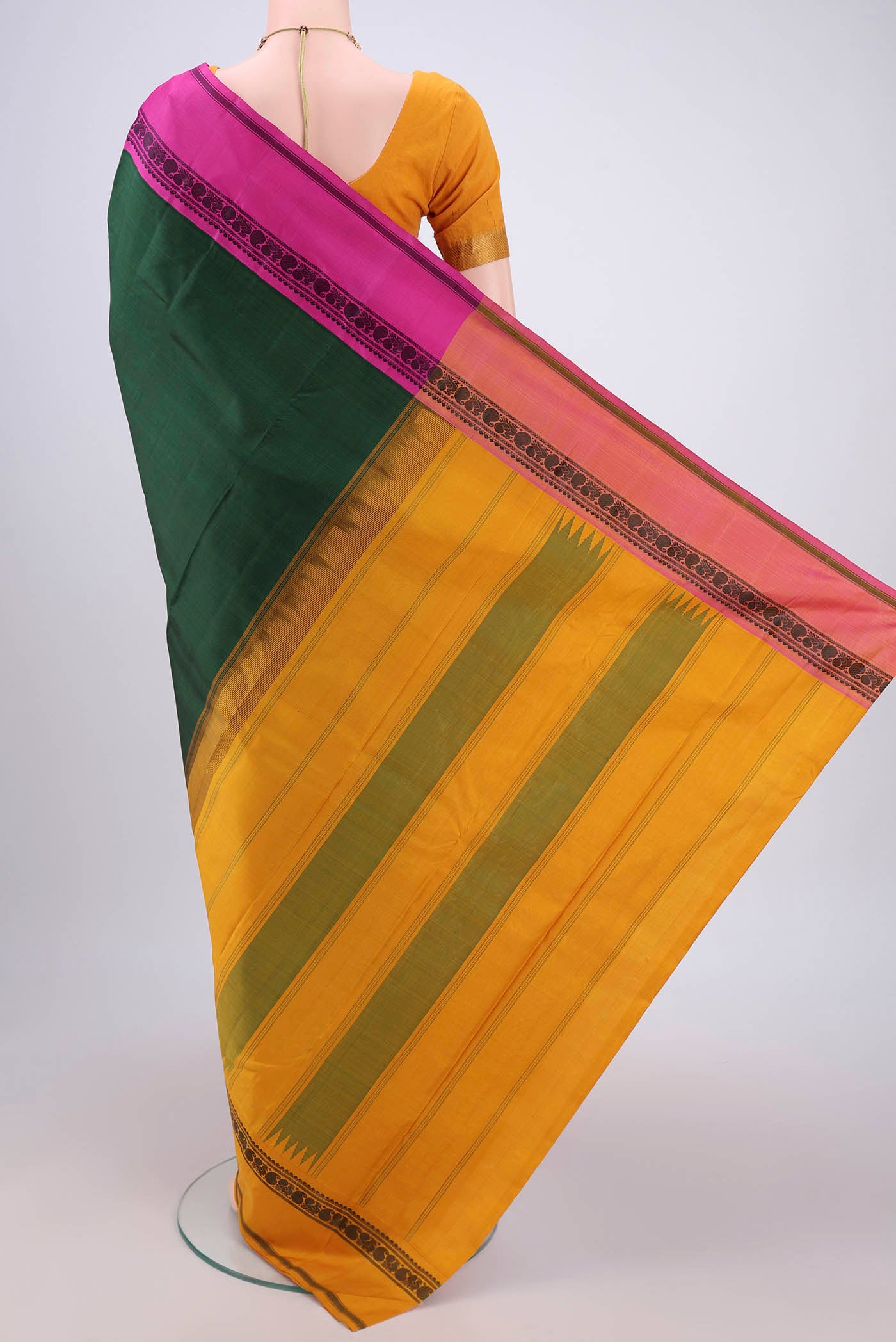 Flat view of Bottle Green Kanjivaram Silk Saree with Plain Body and Ganga Jamuna Border. 