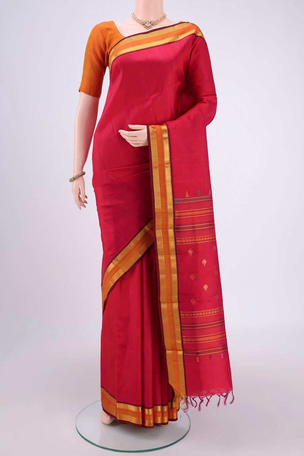 Rani Pink Kanjivaram Silk Saree with Plain Body and Zari Border.  displayed on a mannequin