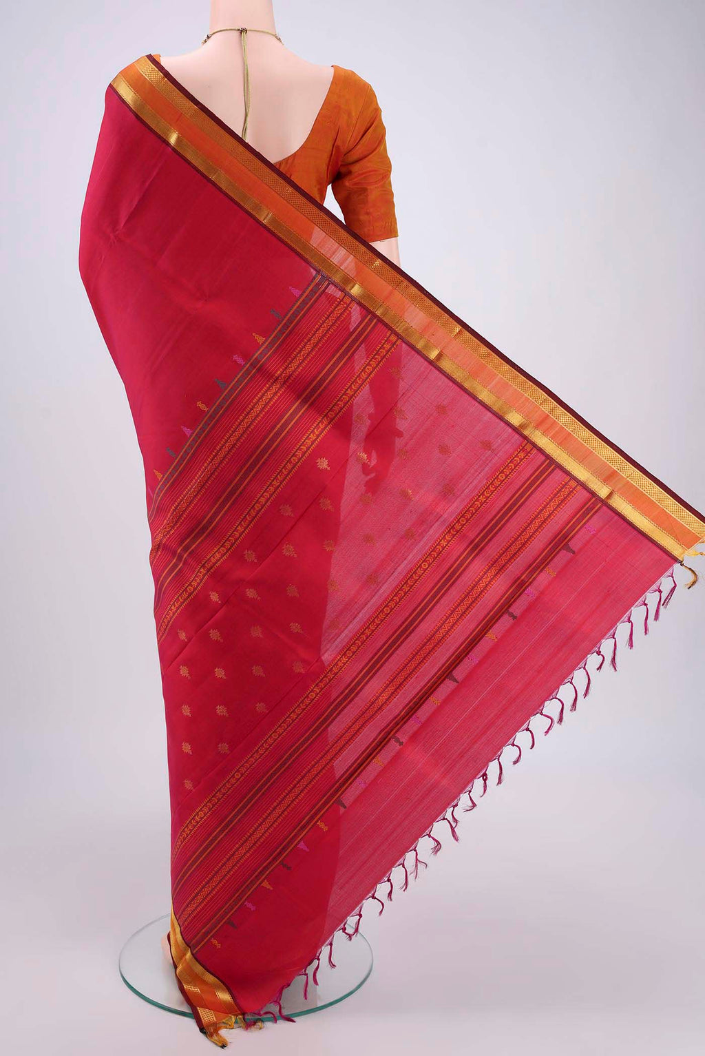 Flat view of Rani Pink Kanjivaram Silk Saree with Plain Body and Zari Border. 