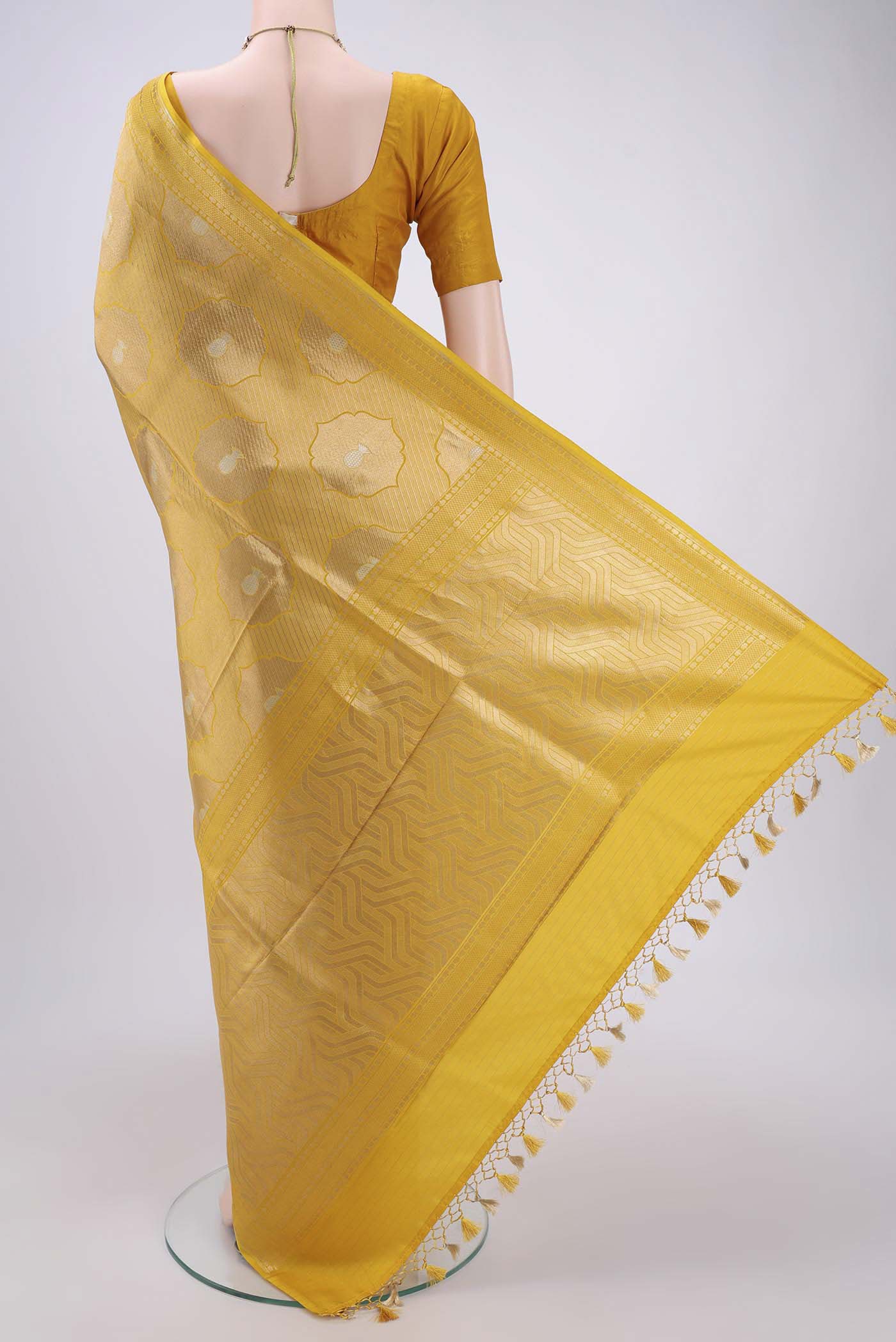 Flat view of Yellow Banarasi Saree with Zari Brocade on the body and Thread Border. 