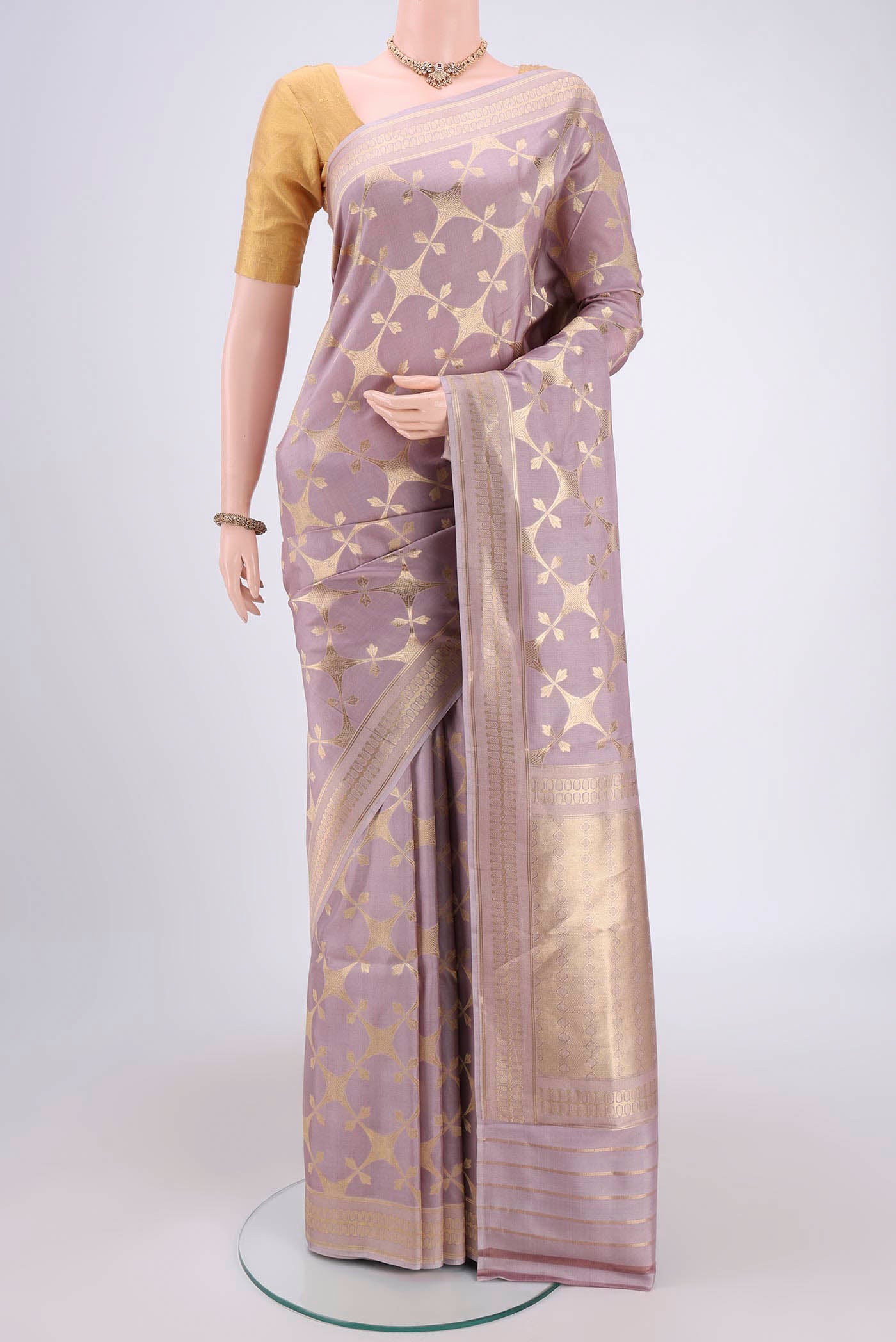 Mauve Banarasi Saree with Zari Brocade on the body and Thread Border.  displayed on a mannequin
