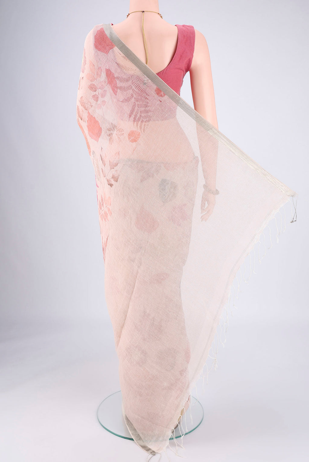 Flat view of Rose Gold Linen Saree with Printed design on the body and Zari Border. 