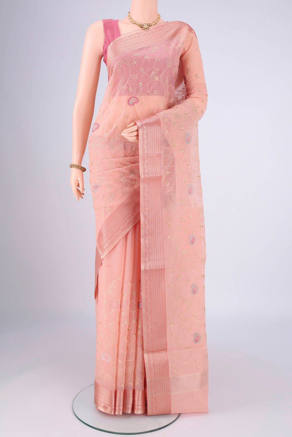 Peach Blended Kota Cotton Saree with Embroidery on the body and Zari Border.  displayed on a mannequin