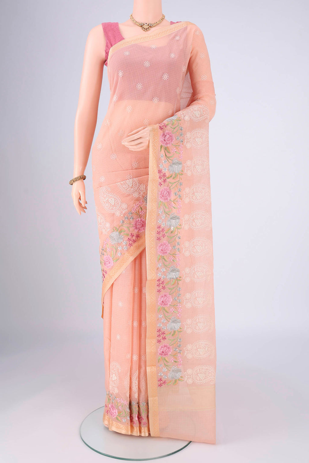 Peach Blended Kota Cotton Saree with Embroidery on the body and Thread Border.  displayed on a mannequin